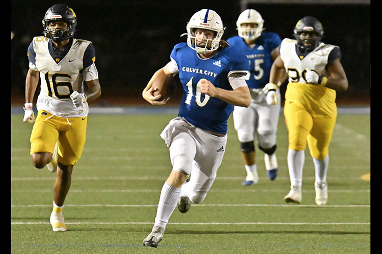 Culver City quarterback Sammy Silvia shows off his running ability against Warren. On this play he gained 29 yards. Silvia has also thrown for 1,287 yards and 17 touchdowns in four games. PHOTO BY GEORGE LAASE